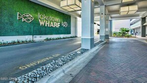 A modern building entrance with a green wall and the text "Lake Town Wharf."