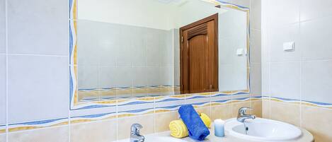 A bathroom with two sinks, a mirror, and a wooden door.