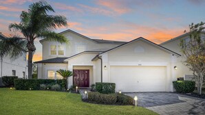A two-story house with a white garage, a red door, and a well-maintained lawn. - Balmoral Breeze 5 Bedrooms (Davenport)