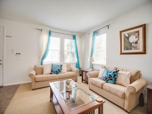 Relax in this stylish living room with two sofas, a coffee table, and a side table, perfect for unwinding.