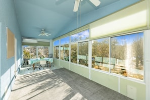 A sunlit room with a large window, a ceiling fan, and a table with chairs. - Amazing Views, 3 blocks from renowned Downtown Prescott (Prescott)