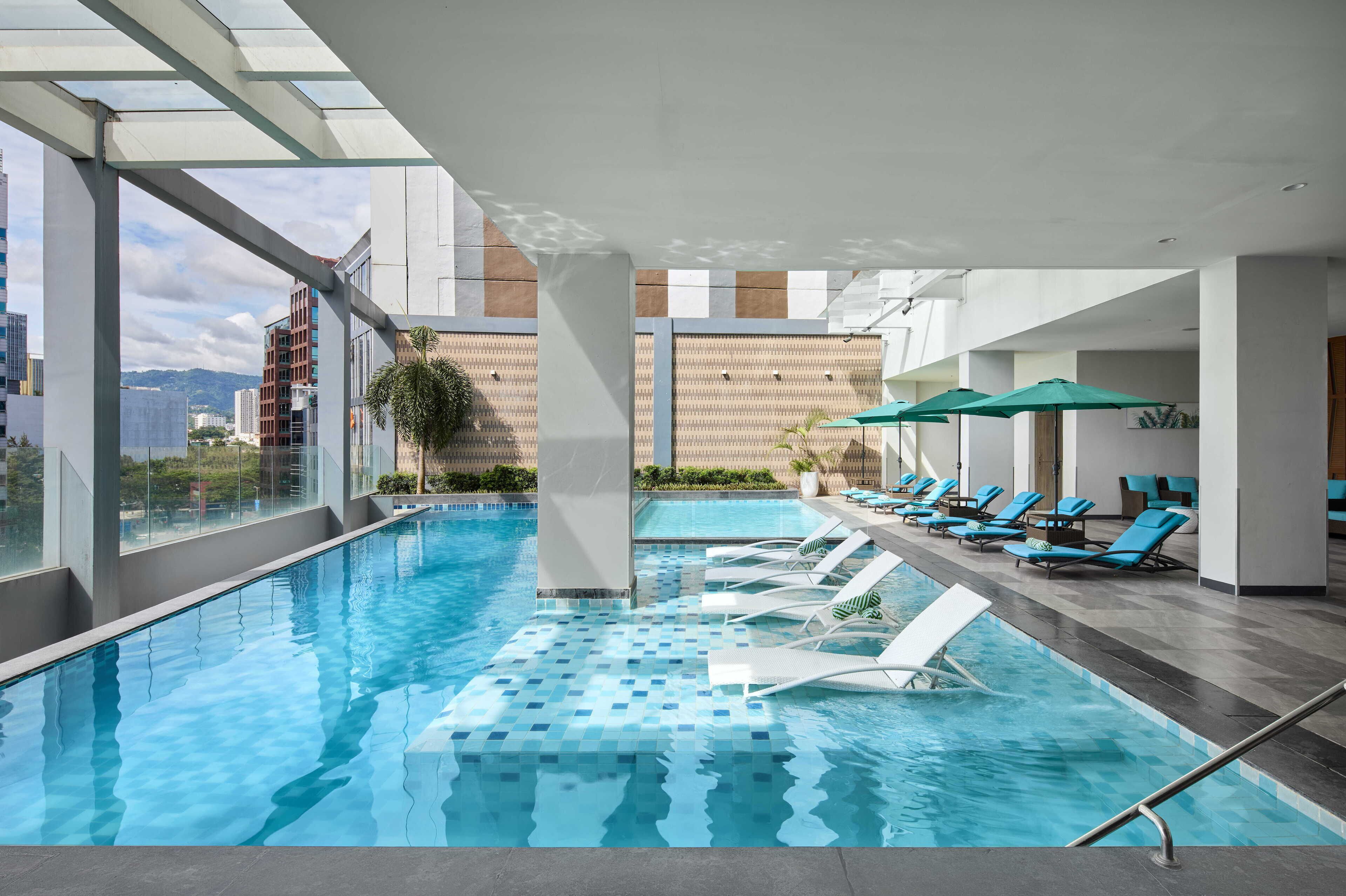 Outdoor pool, open 6:00 AM to 8:00 PM, pool umbrellas, pool loungers