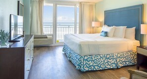 Relax in this stylish room with a large bed, TV, and ocean view.