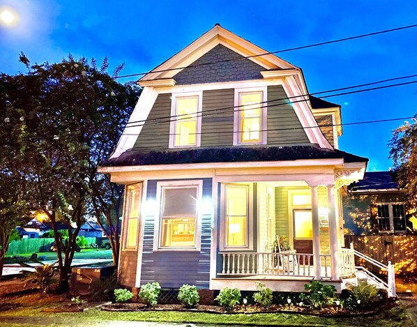 A two-story house with a porch and a front door.