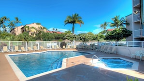 A swimming pool area with two pools, lounge chairs, and palm trees. - Pacific Shores by Maui Rental Group (Kihei)