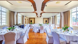 A banquet hall with round tables, white tablecloths, and chairs. - Wigram Hotel (Christchurch)