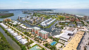 A coastal residential area with high-rise buildings, marina, and water views.