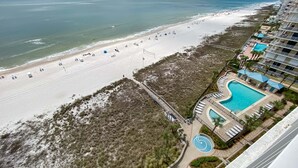 Um resort com praia, piscina e calçadão.