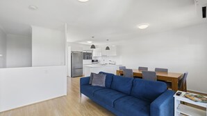 A modern apartment with a living room, dining area, and kitchen. - Top Town Terrace - short walk to town center (Woolgoolga)
