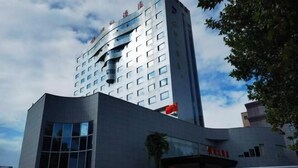 A modern building with a curved facade, large windows, and a prominent entrance. - Yinhe Hotel (Hancheng)