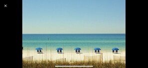 Enjoy a serene beachside retreat with access to the ocean and a wooden fence.