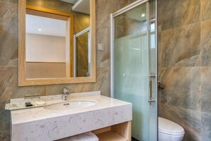 A bathroom with a marble sink, a glass shower enclosure, and a toilet. - Pupeng Boutique Hotel (Yangbi)