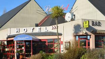 A hotel with a prominent sign, a bar, and a restaurant.