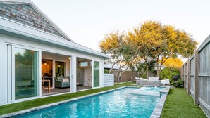 A modern house with a swimming pool, a patio with outdoor furniture, and a large tree with yellow leaves. - Family Tide Retreat/Heated Pool & 2 Spas (St. Augustine)
