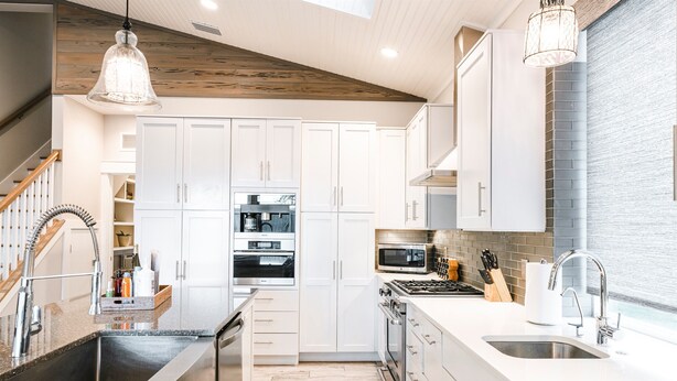 A modern kitchen with white cabinets, stainless steel appliances, and a wooden ceiling. - 2 Masters-Heated Pool & Spa+1 min Walk to Beach (St. Augustine)