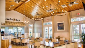 A spacious cafe with wooden ceiling, multiple seating areas, and large windows allowing natural light. - Luxurious Retreat in Naples Reserve! 3 Bedroom Pool House, unwind in style! (Naples)
