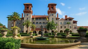 A large, historic building with two prominent towers, a central courtyard with a fountain, and well-maintained landscaping. - Cul-de-sac Hideaway • Cozy Pet-Friendly Mid-Term Stay, Short Drive to Beach (St. Augustine)