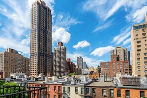 A cityscape with high-rise buildings, a clear sky, and a mix of residential and commercial structures.