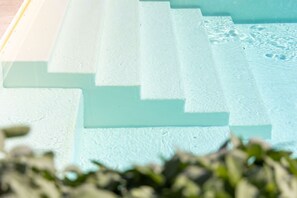 A series of steps leading into a pool area.