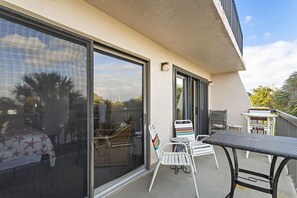 Enjoy the view from this balcony with a glass door leading to a cozy indoor space.