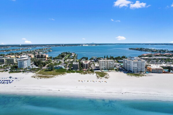 Relax on the wide sandy beach with umbrellas, overlooking the sea from your balcony.