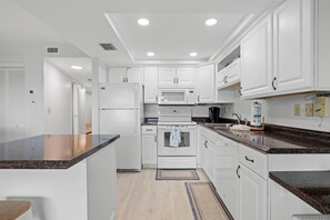 Fridge, microwave, oven, stovetop - 🌊 Unit 207 at Gulf Gate – Modern Bay View Comfort for Up to 4 Guests (St Pete Beach)