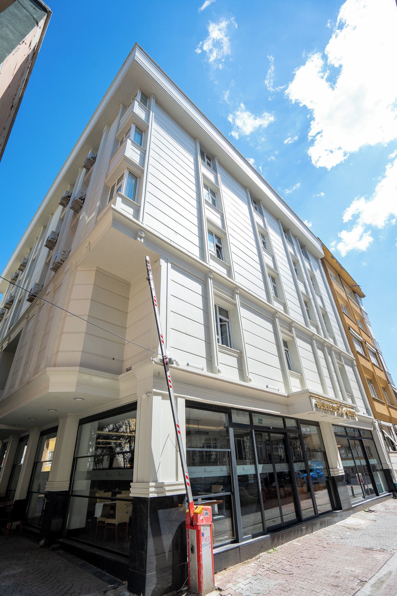 A multi-story building with large windows and a storefront.