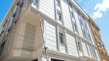 A multi-story building with large windows and a storefront.