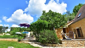 A stone building with outdoor seating, a tree, and umbrellas. - Superb Holiday Home in Busse with Swimming Pool (Besse)