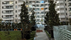 A modern multi-story residential building with balconies, a central courtyard, and potted plants. - Premium Apartment in Copou (Iași)