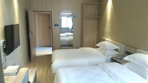 A hotel room with two beds, a TV, a desk, and a wardrobe. - Chaohu Zhongxin Business Hotel (Chaohu)