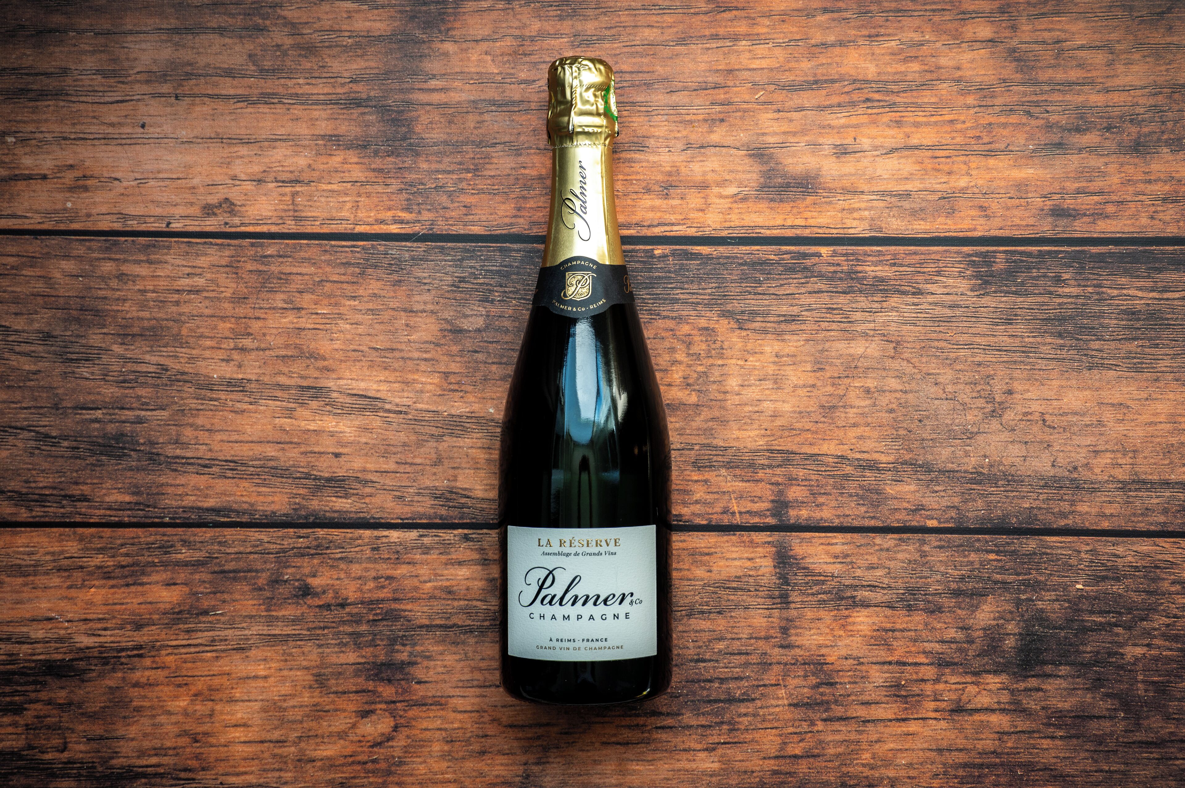 A bottle of champagne on a wooden surface.
