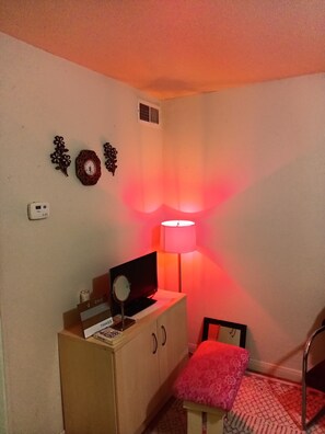 Relax in this inviting space with a flat-screen TV, comfortable chair, and decorative wall art.