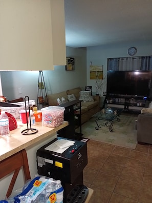 Relax in this cozy space with a comfortable sofa, flat-screen TV, and convenient amenities.