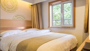 A neatly made bed with a headboard, a window with curtains, and a desk with a lamp. - GreenTree Inn (Beijing Hospital of Traditional Chinese Medicine, Nanluogu Lane, Houhai) (Beijing)