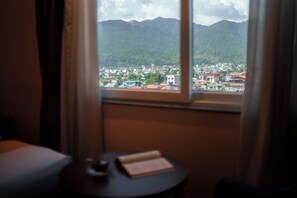 A room with a window overlooking a town and mountains. - Dream International Hotel (Butwal)