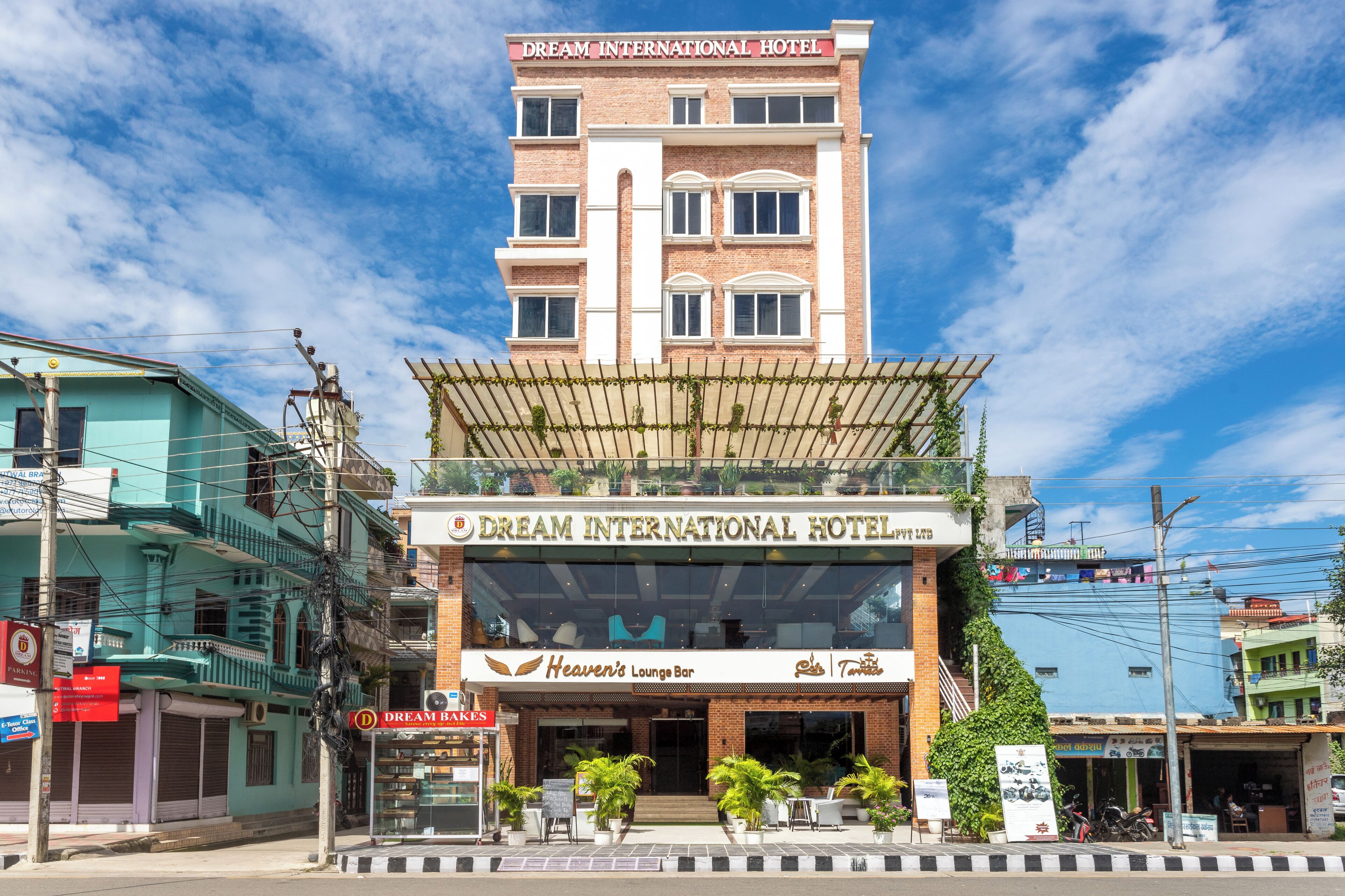The exterior of Dream International Hotel with a visible sign for Heaven's Lounge Bar.