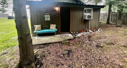 Waterfront log home on Elk Lake with dock and mooring, window A/C. Pet ok.