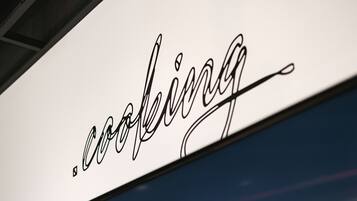 A sign with the word "cooking" in a stylized font.