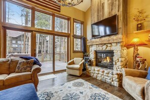 Cozy living area with a fireplace, comfortable seating, and a flat-screen TV.