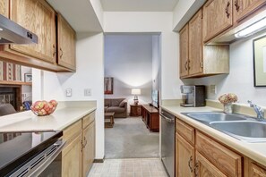 Enjoy cooking in this well-equipped kitchen with a stainless steel sink and coffee maker.
