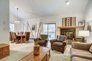 Relax in this inviting living room with a fireplace, dining table, and comfortable seating area.