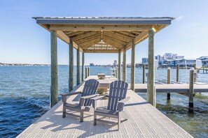 Guests can enjoy a peaceful moment on the pier's covered seating area, surrounded by the soothing sounds of the water.