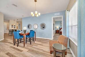 Unified Elegance: The kitchen, dining, and living areas come together in seamless harmony. A space where culinary delights, shared meals, and relaxation intertwine, creating an atmosphere of unity and elegance for all to enjoy. - Disney near: 3BR Lakeview Balcony Condo (Orlando)