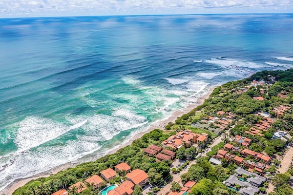 Aerial view of Langosta Beach and Tamarindo’s coastal neighborhood—Guapinol condo sits in a quiet, walkable area near the ocean, surf spots, and vibrant dining. A perfect blend of tranquility and tropical adventure.
