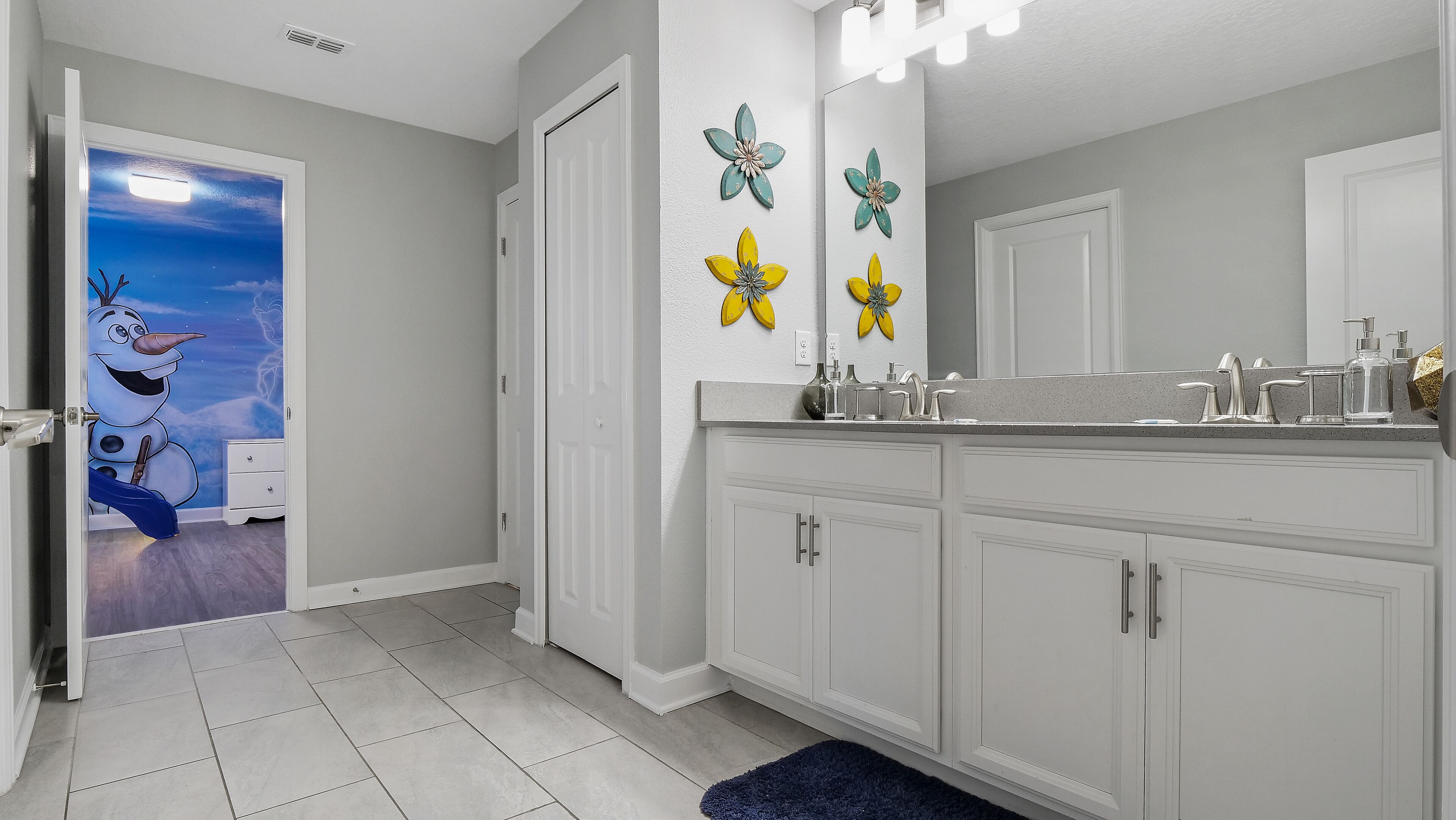 A bathroom with a vanity, a sink, and a mirror.