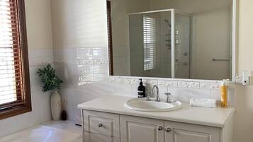 Bathtub, hair dryer, towels, shampoo