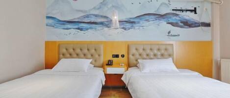 A hotel room with two beds, a mural of mountains and birds, a bedside lamp, and an air conditioning unit.