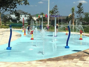 A water play area with multiple water jets and a tiled floor.