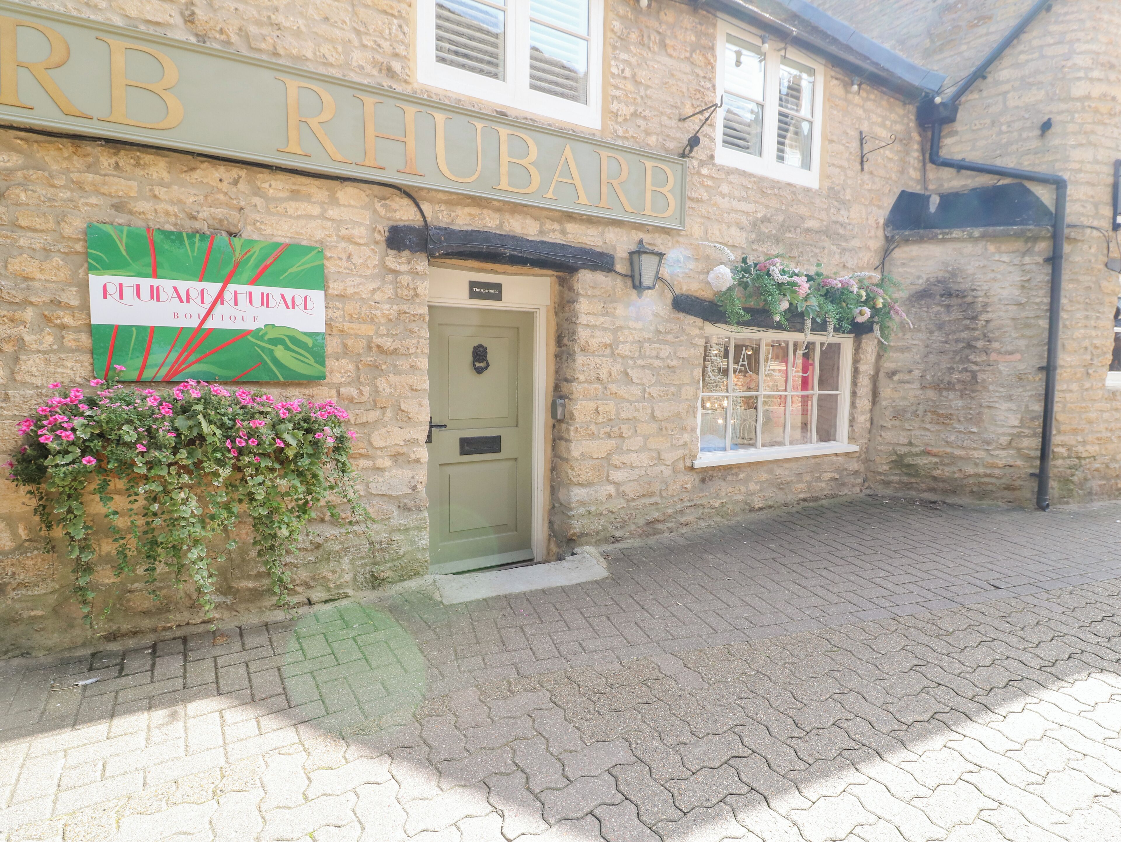 A stone building with a sign reading "RHUBARB BOUTIQUE."